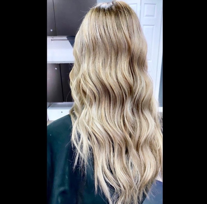 Dimensional blonde balayage with a soft shadow root and a lived-in grow-out, by Hello Beauty Lounge in Red Deer