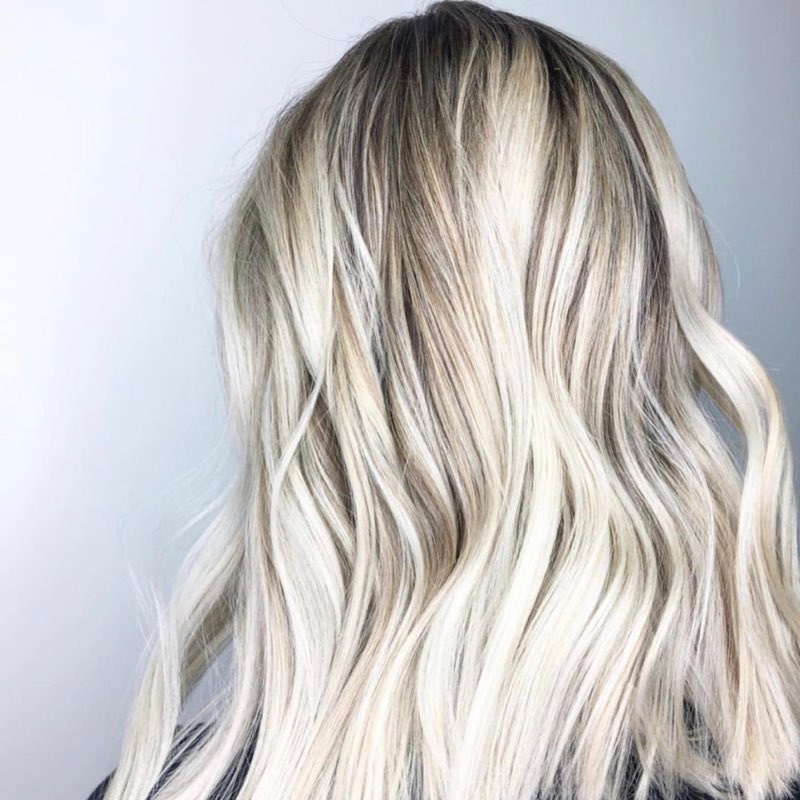 Hand-tied extensions blended into long blonde hair