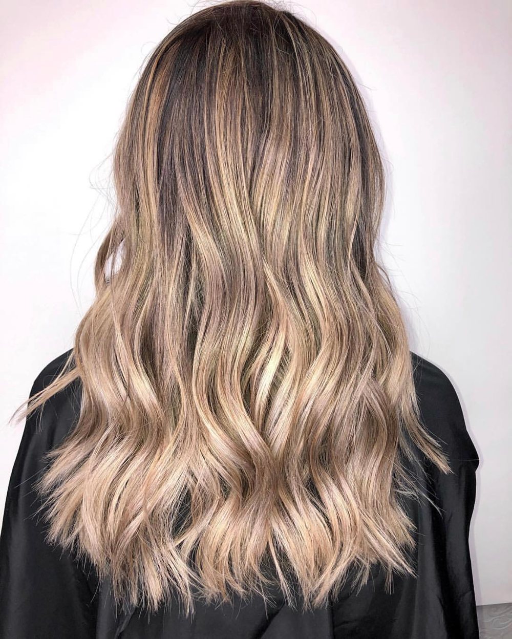 Warm beige balayage kept deliberately soft at the root